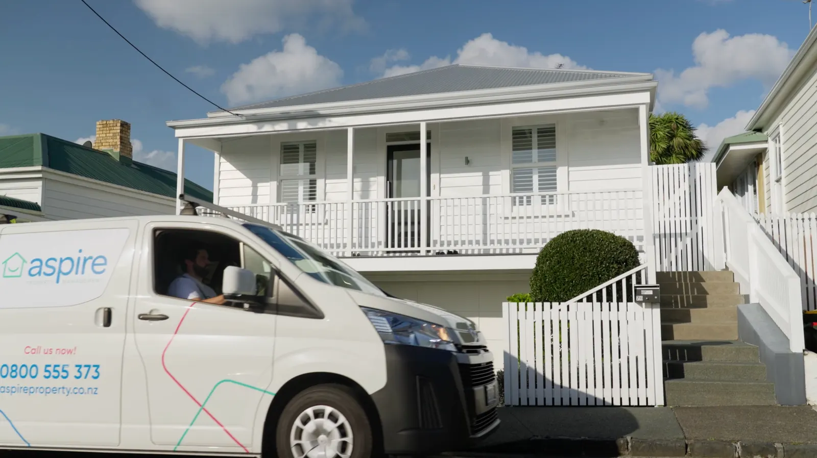 An Aspire van outside a white villa in Auckland
